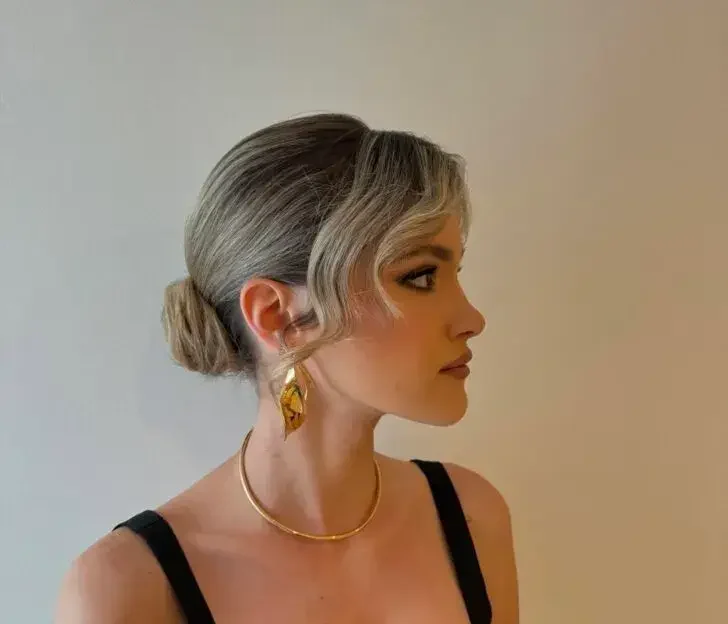 Elegant Low Bun with Soft Face-Framing Curls Elegant Low Bun with Soft Face-Framing Curls