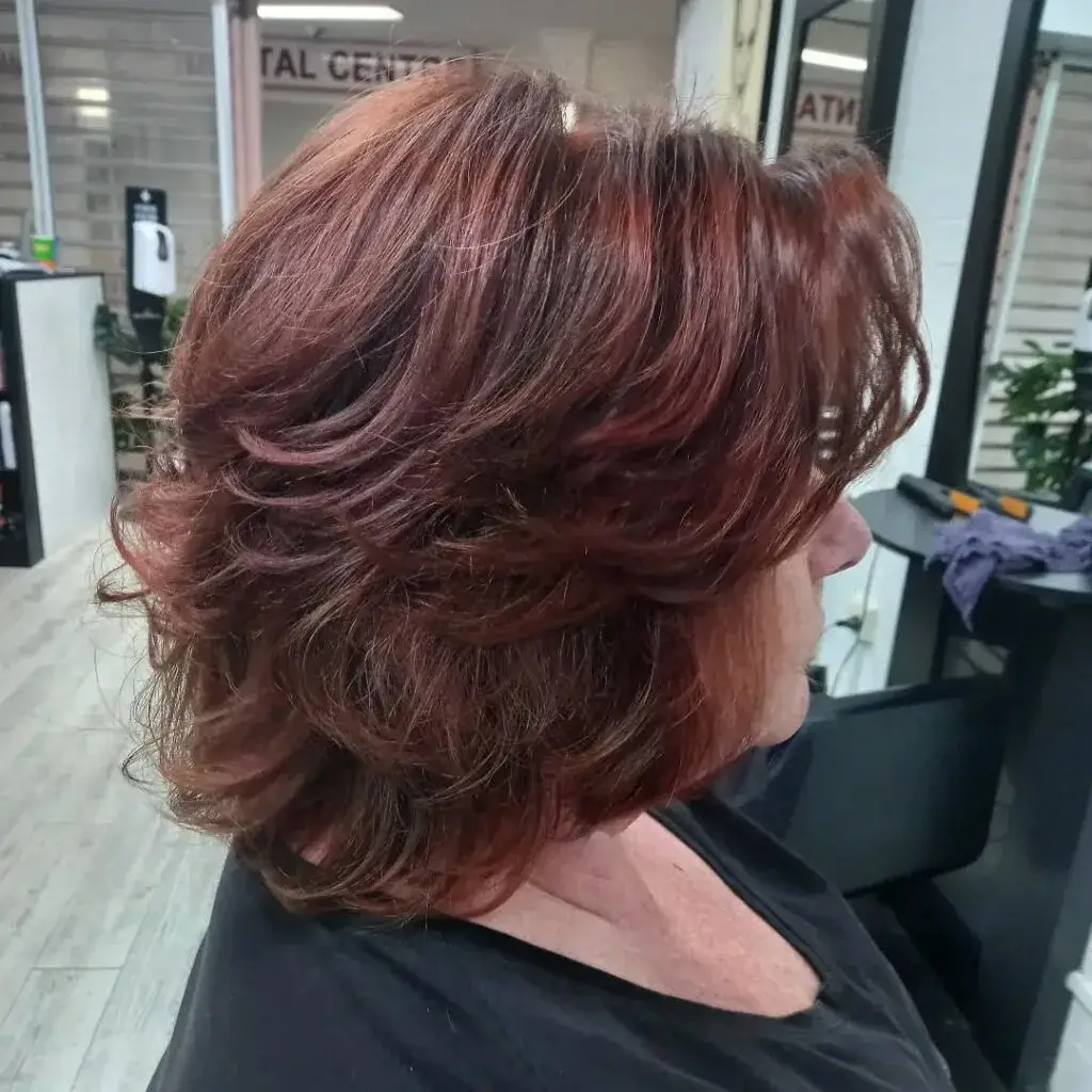 Layered Shoulder-Grazing Cut with Soft Curls